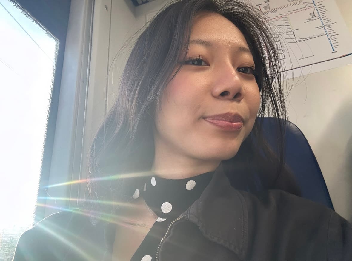 Nicole Do seated by a sunny window