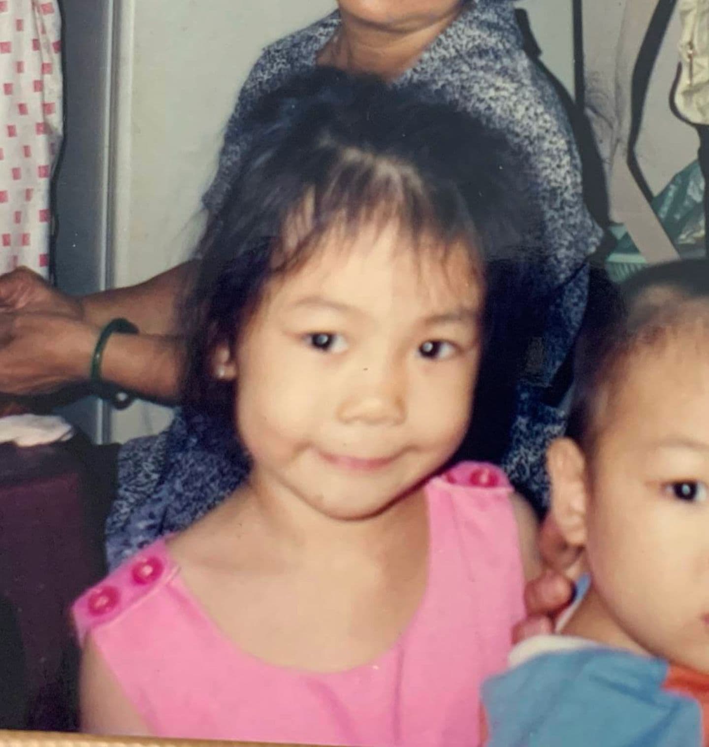 Nicole Đỗ smiling as a child